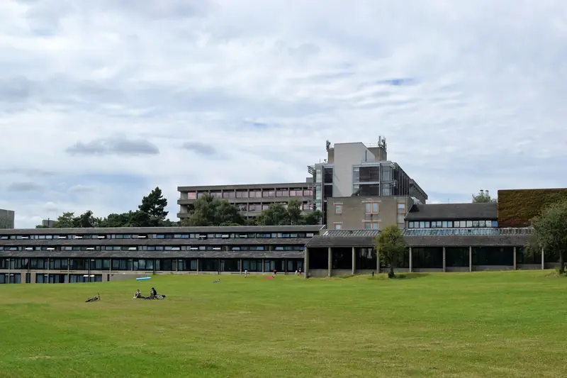 Low-rise university accommodation blocks behind a wide lawn at the University of East Anglia