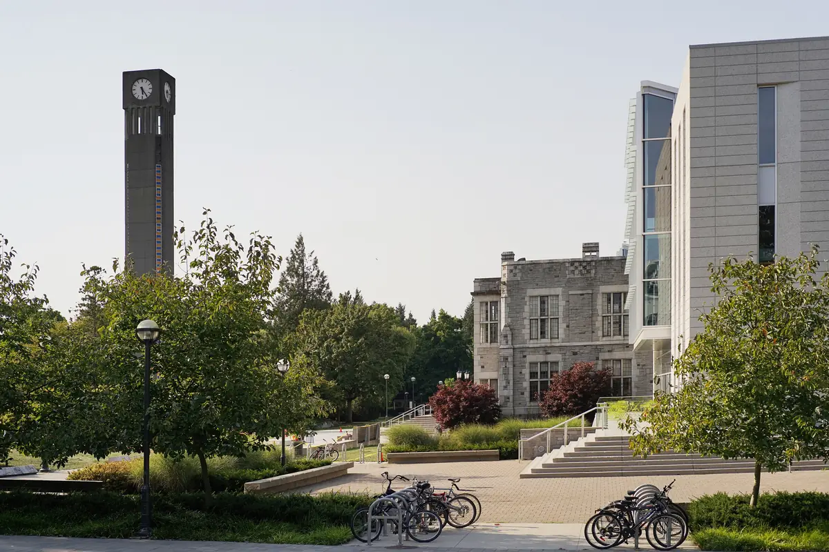 The clock tower and the Irving K. Barber Learning Centre at the University of British Columbia, with trees and parked bicycles